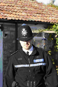 A British &ldquo;Bobby&rdquo; or policeman in typical uniform.